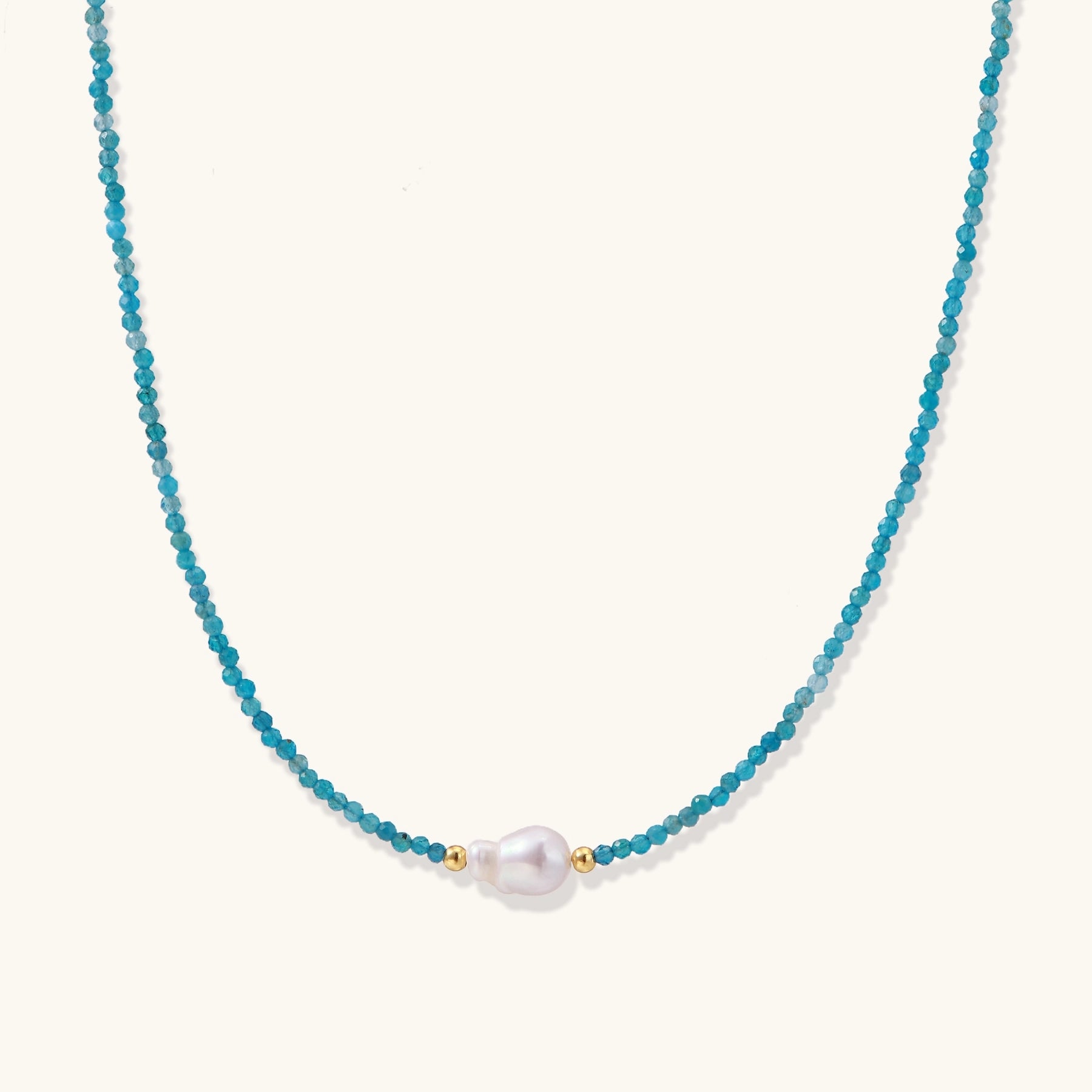 Delicate necklace featuring small turquoise apatite beads with a central freshwater pearl on sterling silver chain