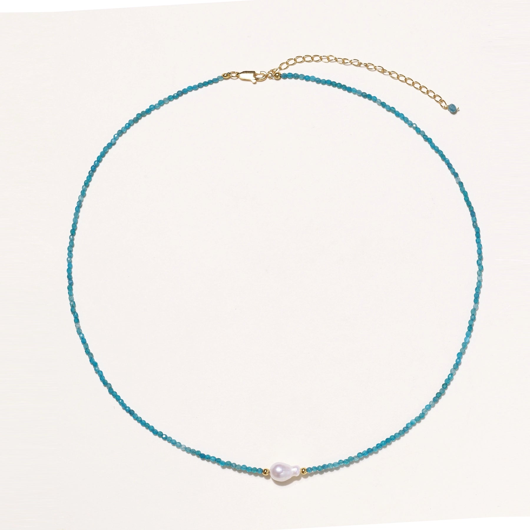 Delicate necklace featuring small turquoise apatite beads with a central freshwater pearl on sterling silver chain