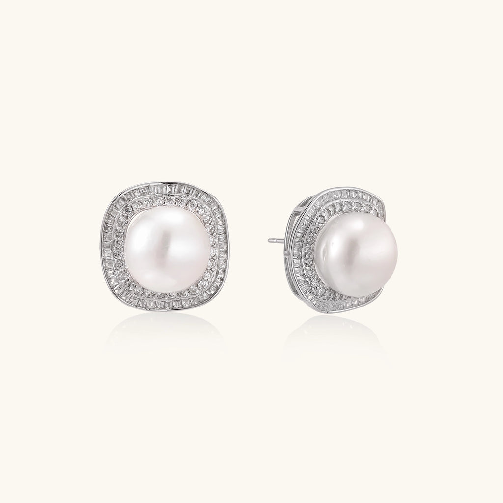 Sterling silver stud earrings with round freshwater pearls surrounded by sparkling crystal halos on white background.