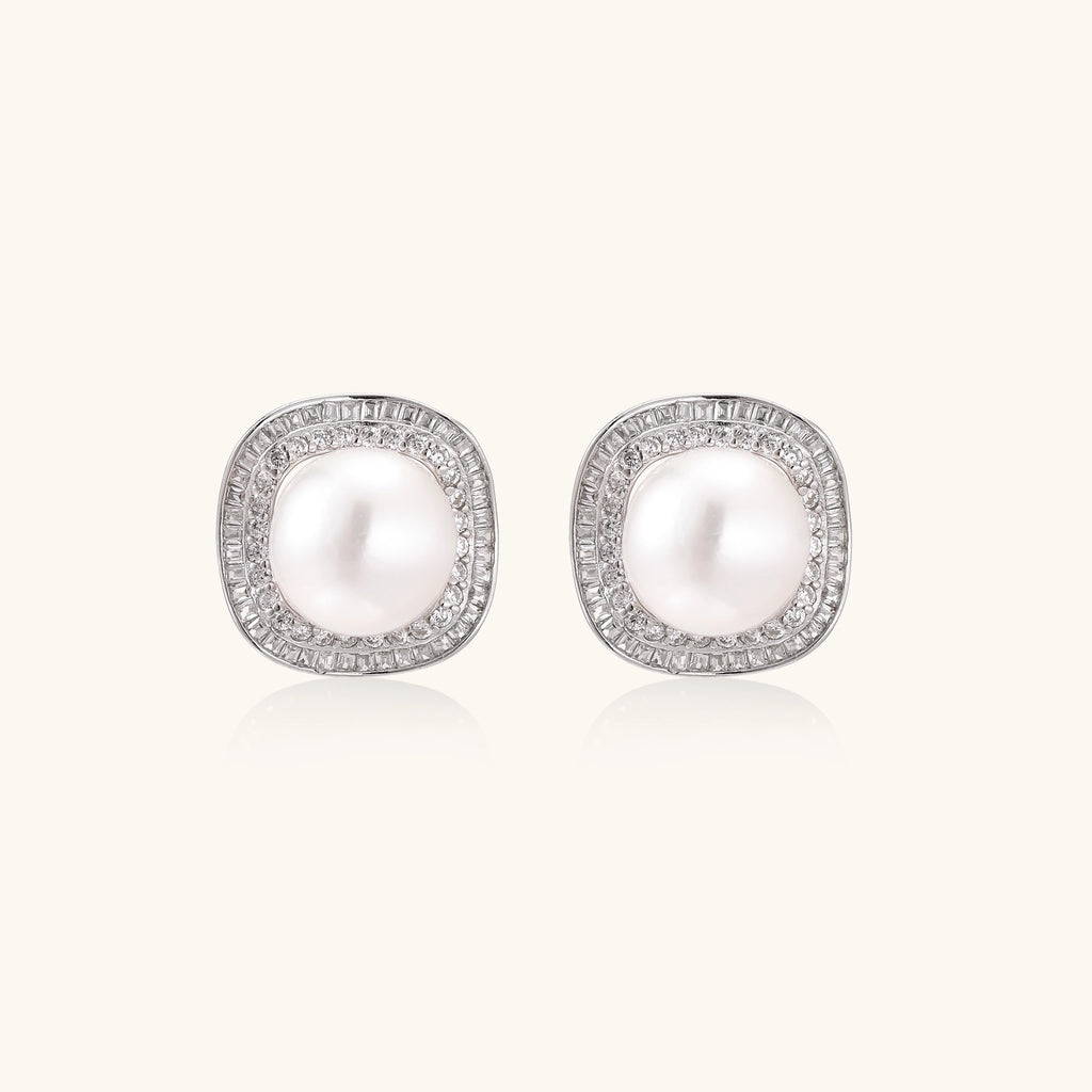 Sterling silver stud earrings with round freshwater pearls surrounded by sparkling crystal halos on white background.