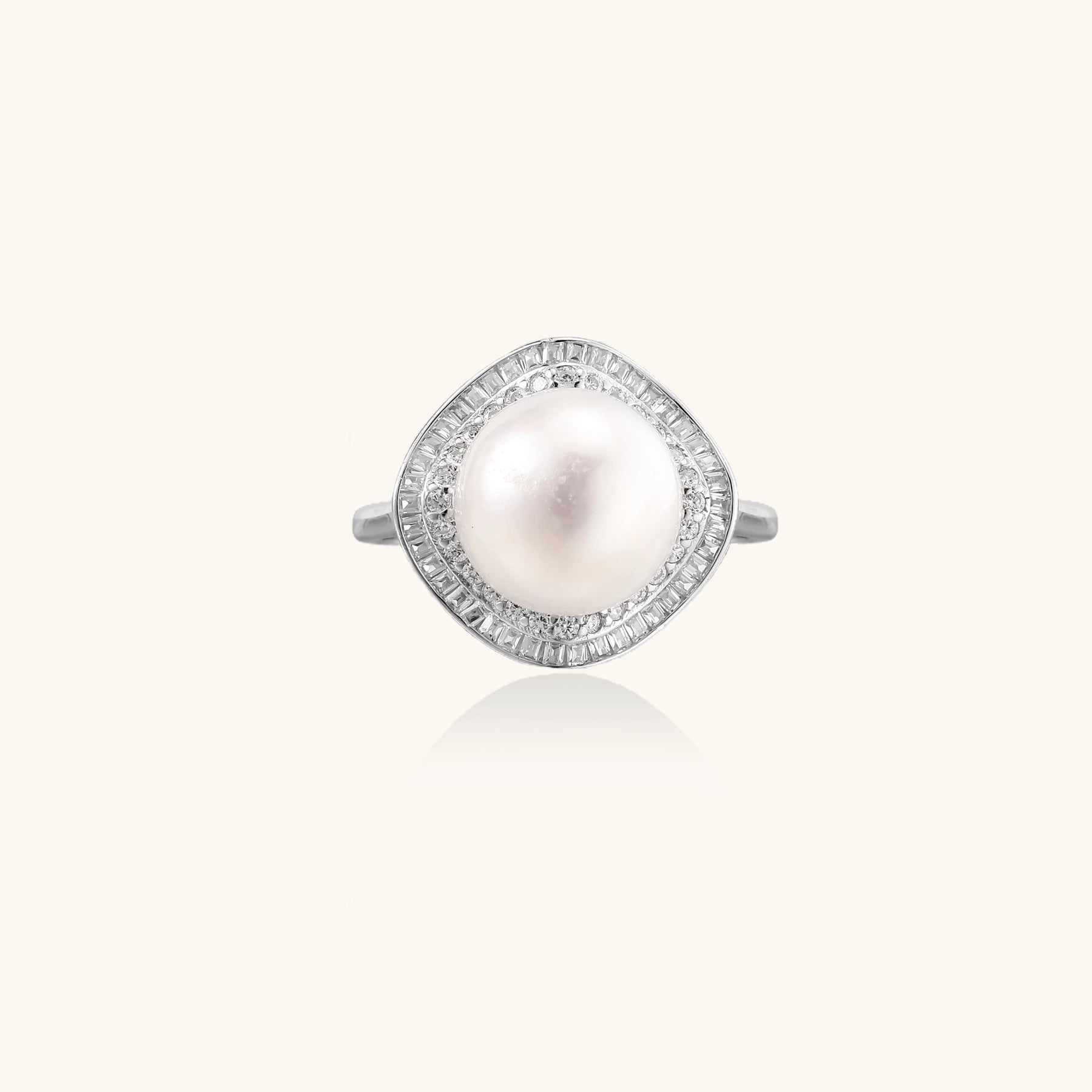 Sterling silver ring with 11mm freshwater pearl surrounded by double diamond halo on white background.