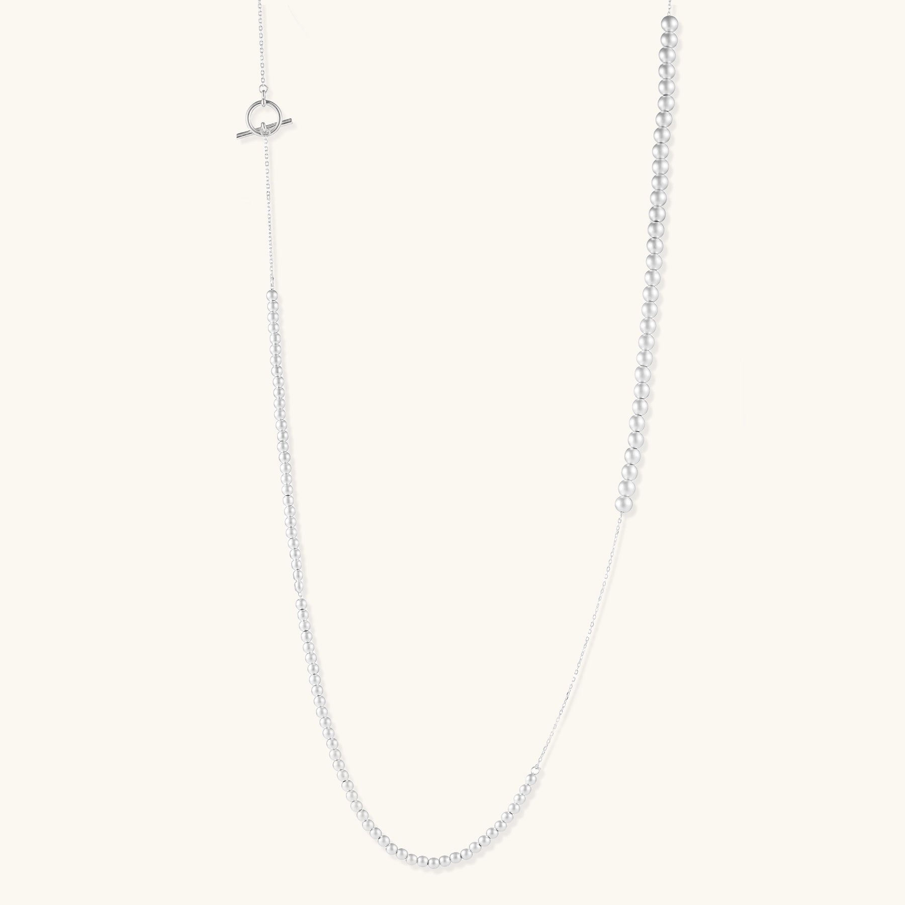 Sterling silver necklace with graduated pearl beads and delicate chain sections featuring a toggle clasp closure.
