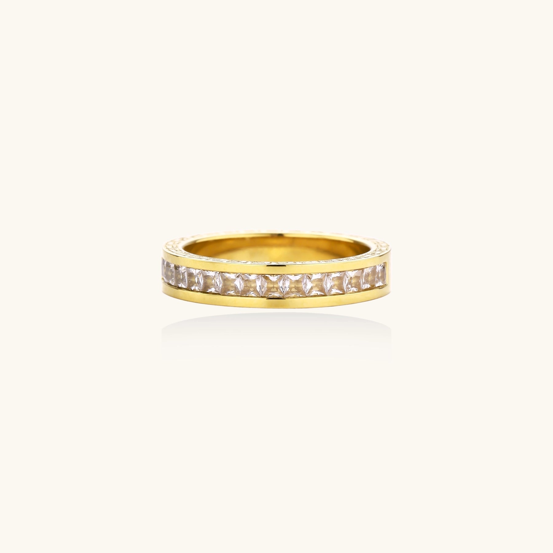 14K gold plated ring with channel-set zirconia stones and Greek key pattern engraved on sides on white background