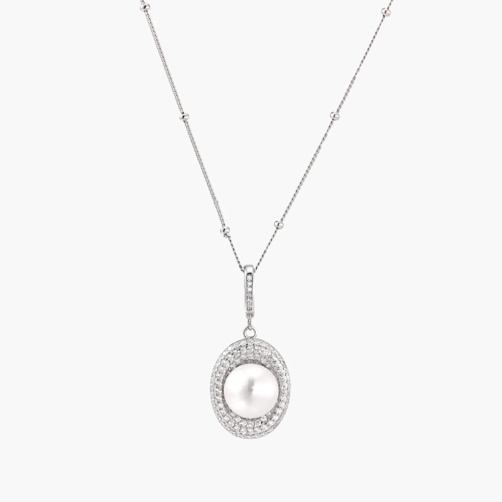 Oval sterling silver pendant with crystal halo surrounding a white freshwater pearl on delicate chain