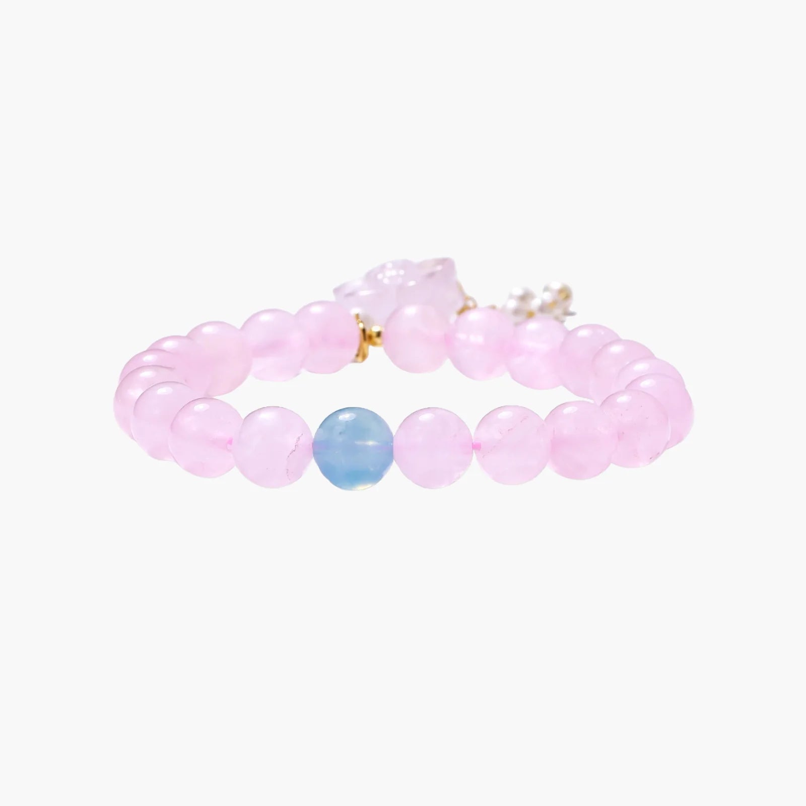 Stretchy beaded bracelet with pink rose quartz, blue aquamarine, carved floral pendant, and pearl tassel clasp.
