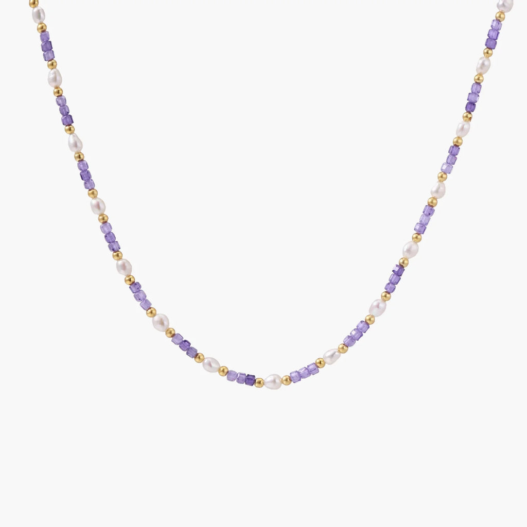 Delicate 18K gold vermeil necklace with alternating lavender zirconia beads and white freshwater pearls on cream background